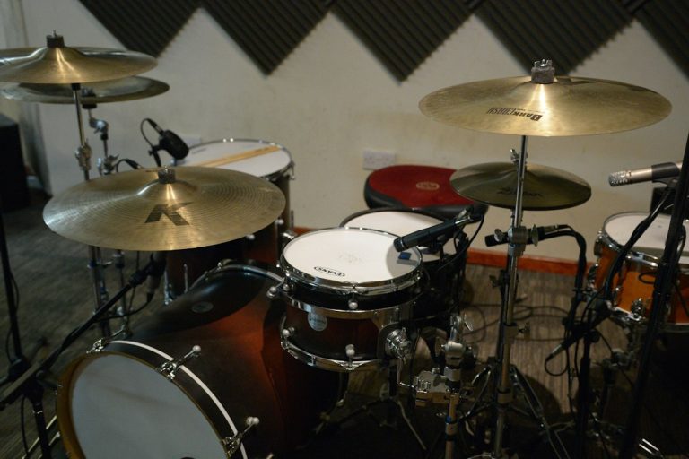 Drum kit with microphones set up in a recording studio