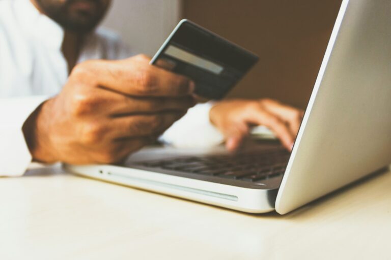 Person entering credit card details on laptop